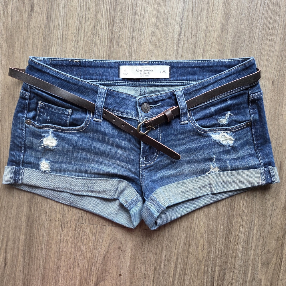 Abercrombie & Fitch distressed low-rise denim shorts paired with a leather Belt